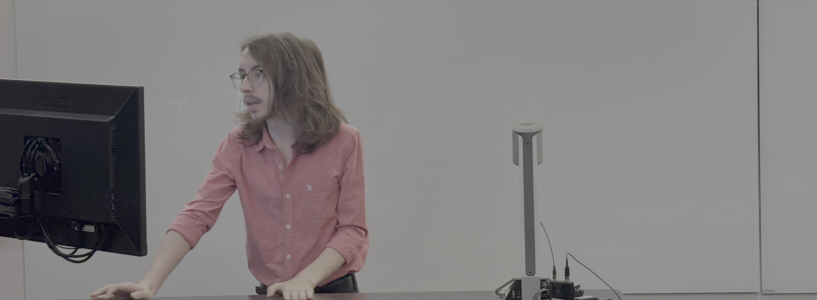 A person standing in front of a white board